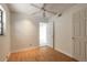 Bedroom featuring wood floors, ceiling fan, closet, and bright natural light at 4734 S Atlantic Ave, Ponce Inlet, FL 32127