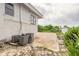 Side view of the home featuring a patio, and lush green landscaping at 4734 S Atlantic Ave, Ponce Inlet, FL 32127