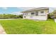 Two-story home surrounded by lush lawn and featuring mature landscaping at 4734 S Atlantic Ave, Ponce Inlet, FL 32127