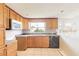 Traditional kitchen featuring wood cabinets, tiled countertops, and stainless-steel appliances at 4734 S Atlantic Ave, Ponce Inlet, FL 32127
