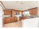 Traditional kitchen with tiled floor, wood cabinets, and modern appliances at 4734 S Atlantic Ave, Ponce Inlet, FL 32127