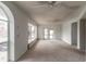 Bright, sun-filled living room with large windows and neutral carpeting at 4734 S Atlantic Ave, Ponce Inlet, FL 32127