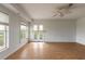 Living room features wood floors, a ceiling fan, and French doors to the backyard at 4734 S Atlantic Ave, Ponce Inlet, FL 32127