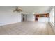 Open living room with tiled floor, ceiling fan, connecting to the kitchen at 4734 S Atlantic Ave, Ponce Inlet, FL 32127