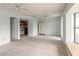 Open-concept living area with neutral tones leads to the kitchen at 4734 S Atlantic Ave, Ponce Inlet, FL 32127