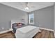 Comfortable bedroom featuring a ceiling fan, natural light, and wood-look floors at 510 Silvergate Loop, Lake Mary, FL 32746
