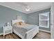 Cozy bedroom featuring hardwood floors, a ceiling fan, and a window with natural light, creating a relaxing space at 510 Silvergate Loop, Lake Mary, FL 32746