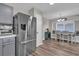 Kitchen with stainless steel refrigerator with attached dining area with cushioned bench seating and chandelier at 510 Silvergate Loop, Lake Mary, FL 32746
