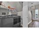 Functional laundry room with modern washer and dryer, storage shelving, and convenient access to the staircase at 510 Silvergate Loop, Lake Mary, FL 32746