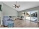 Open living room with large windows and sliding glass door, wood look flooring, and comfortable seating at 510 Silvergate Loop, Lake Mary, FL 32746
