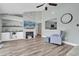 Comfortable living room with vaulted ceilings, fireplace, ceiling fan, and wood look flooring at 510 Silvergate Loop, Lake Mary, FL 32746