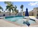 Relaxing pool area featuring palm trees, a privacy fence, and a shed; perfect for hot summer days at 510 Silvergate Loop, Lake Mary, FL 32746