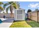 Backyard shed with a white door and trim, set among green grass and a privacy fence, providing extra storage at 510 Silvergate Loop, Lake Mary, FL 32746