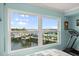 The main bedroom boasts scenic water views from large windows, flooding the room with natural light at 525 Marina Point Dr # 5250, Daytona Beach, FL 32114