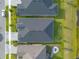 Birds-eye view of a backyard with stone patio, firepit, and well-manicured lawn at 6271 W Fallsgrove Ln, Port Orange, FL 32128