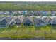 An aerial shot showing well-planned community with lush green lawns extending to the lake at 6271 W Fallsgrove Ln, Port Orange, FL 32128