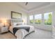 This bedroom features lots of natural light, neutral decor, and beautiful outdoor scenery at 6271 W Fallsgrove Ln, Port Orange, FL 32128
