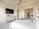 This bedroom features an ensuite bathroom, wall-mounted television and neutral decor at 6271 W Fallsgrove Ln, Port Orange, FL 32128