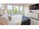 This bedroom features lots of natural light, neutral decor, and a wall-mounted television at 6271 W Fallsgrove Ln, Port Orange, FL 32128