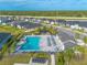 Aerial view of a community pool with lounge chairs, umbrellas, and well-kept landscaping at 6271 W Fallsgrove Ln, Port Orange, FL 32128