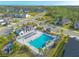 An aerial view showcases the community pool area with lounge seating and a nearby playground at 6271 W Fallsgrove Ln, Port Orange, FL 32128