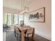 Modern dining room with decorative light fixture and view of backyard at 6271 W Fallsgrove Ln, Port Orange, FL 32128