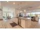 Open floor plan with a modern kitchen featuring a large center island and seamless flow to the living area at 6271 W Fallsgrove Ln, Port Orange, FL 32128