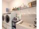 The laundry room features a modern washer and dryer, and dog wash station at 6271 W Fallsgrove Ln, Port Orange, FL 32128