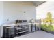 Built-in stainless steel outdoor kitchen with grill, pizza oven, sink, fridge, and storage at 6271 W Fallsgrove Ln, Port Orange, FL 32128