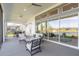 Covered patio with large sliding glass doors offering scenic water views and comfortable outdoor seating at 6271 W Fallsgrove Ln, Port Orange, FL 32128