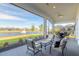 Relaxing screened-in patio with lake view, features comfortable seating and outdoor dining area at 6271 W Fallsgrove Ln, Port Orange, FL 32128
