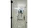 Bathroom featuring white vanity with modern black hardware and stylish white hexagon tile flooring at 679 Rhodes Dr, Deland, FL 32720