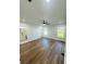 Bright bedroom features wood-look flooring, a ceiling fan, recessed lights, and an ensuite bathroom at 679 Rhodes Dr, Deland, FL 32720