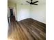 This bedroom features a ceiling fan, a closet, hardwood floors, and neutral walls at 679 Rhodes Dr, Deland, FL 32720
