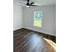 Bright bedroom with natural light, wood floors, and a ceiling fan at 679 Rhodes Dr, Deland, FL 32720