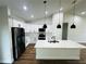Bright modern kitchen showcasing stainless steel appliances, ample counter space, and stylish pendant lighting at 679 Rhodes Dr, Deland, FL 32720