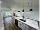 Modern kitchen features new stainless steel appliances, marble countertops, and an open floor plan at 679 Rhodes Dr, Deland, FL 32720