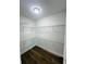 Walk-in closet with wood flooring and wire shelving at 679 Rhodes Dr, Deland, FL 32720