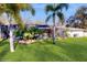 Backyard with lush green lawn, mature trees, pool and lanai at 7108 East Rd, Lakeland, FL 33809
