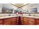 Bathroom featuring double sinks, wood cabinets and large mirrors at 7108 East Rd, Lakeland, FL 33809