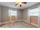 Bright bedroom with wood-style tile flooring, two windows with blinds and sheer curtains at 7108 East Rd, Lakeland, FL 33809