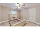 Cozy bedroom features decorative ceiling fan and empty bed frame on wood-look flooring at 7108 East Rd, Lakeland, FL 33809