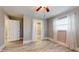 Bright bedroom features wood-look flooring, neutral walls, and bright, sheer curtains at 7108 East Rd, Lakeland, FL 33809