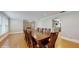 Open dining room with wood floors, molding and a table with seating for eight at 7108 East Rd, Lakeland, FL 33809