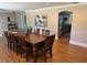 Bright dining room with wood floors, wooden furniture and views into kitchen at 7108 East Rd, Lakeland, FL 33809