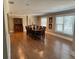 Open dining room with wood floors, a wooden table, chairs, and large windows at 7108 East Rd, Lakeland, FL 33809