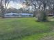 Charming single story home with a sprawling front lawn and mature trees at 7108 East Rd, Lakeland, FL 33809