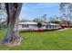 Charming home featuring a well-manicured lawn, and inviting curb appeal at 7108 East Rd, Lakeland, FL 33809
