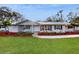 Charming single-story home with well-manicured lawn and landscaped garden beds at 7108 East Rd, Lakeland, FL 33809