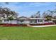Inviting one-story home with manicured landscaping, walkway leading to the front entrance at 7108 East Rd, Lakeland, FL 33809